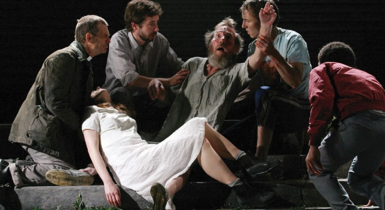 Six people gathered behind a sofa