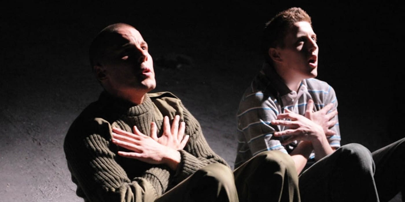 Two men going situps with their arms crossed over their chests.