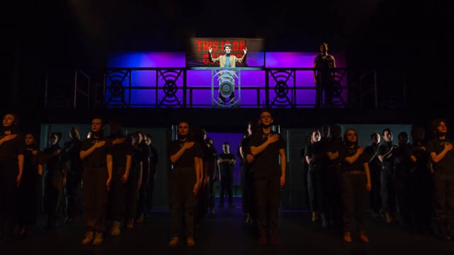 A person on a higher level talking to a crowd under them of soldiers