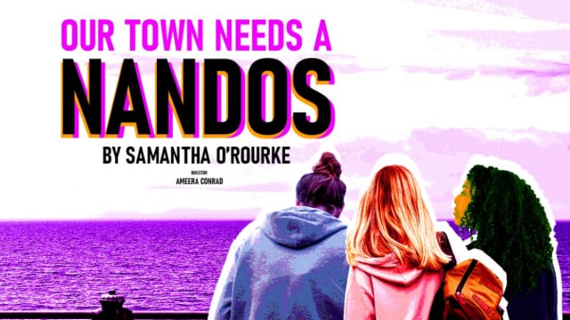 The back of three girls looking toward a body of purple water.