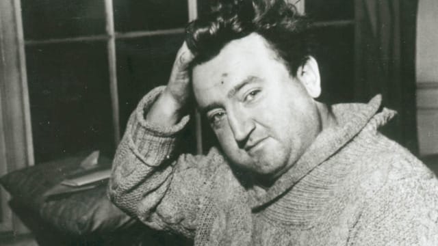 A man leaning on a side with his hand propping up his head