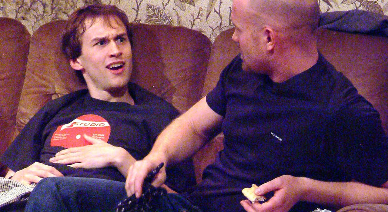 Two men sat on a sofa