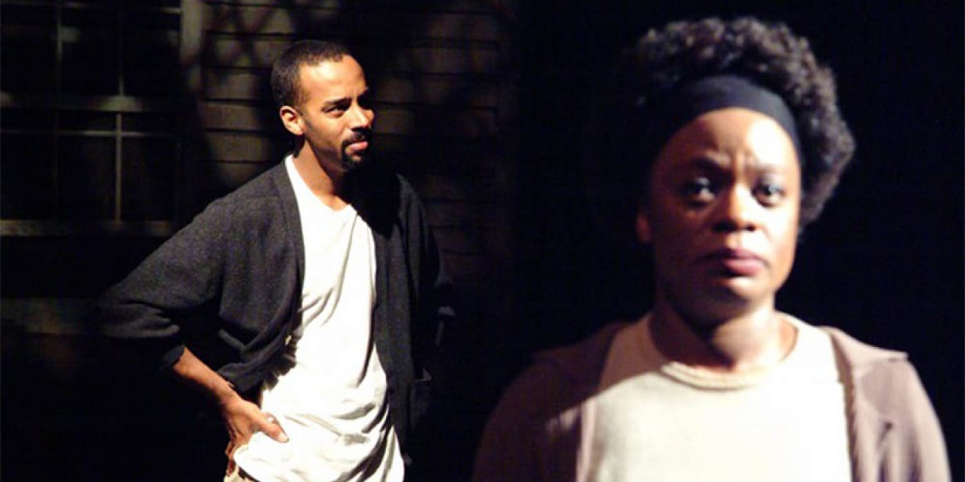 A man and a woman wearing white tops and cardigans.